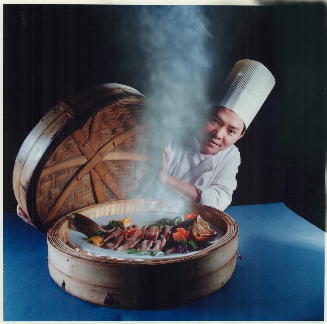 Something's fishy: Peter Chow, executive chef of Toronto's Mandarin Club, displays steamed grouper with ham and mushrooms