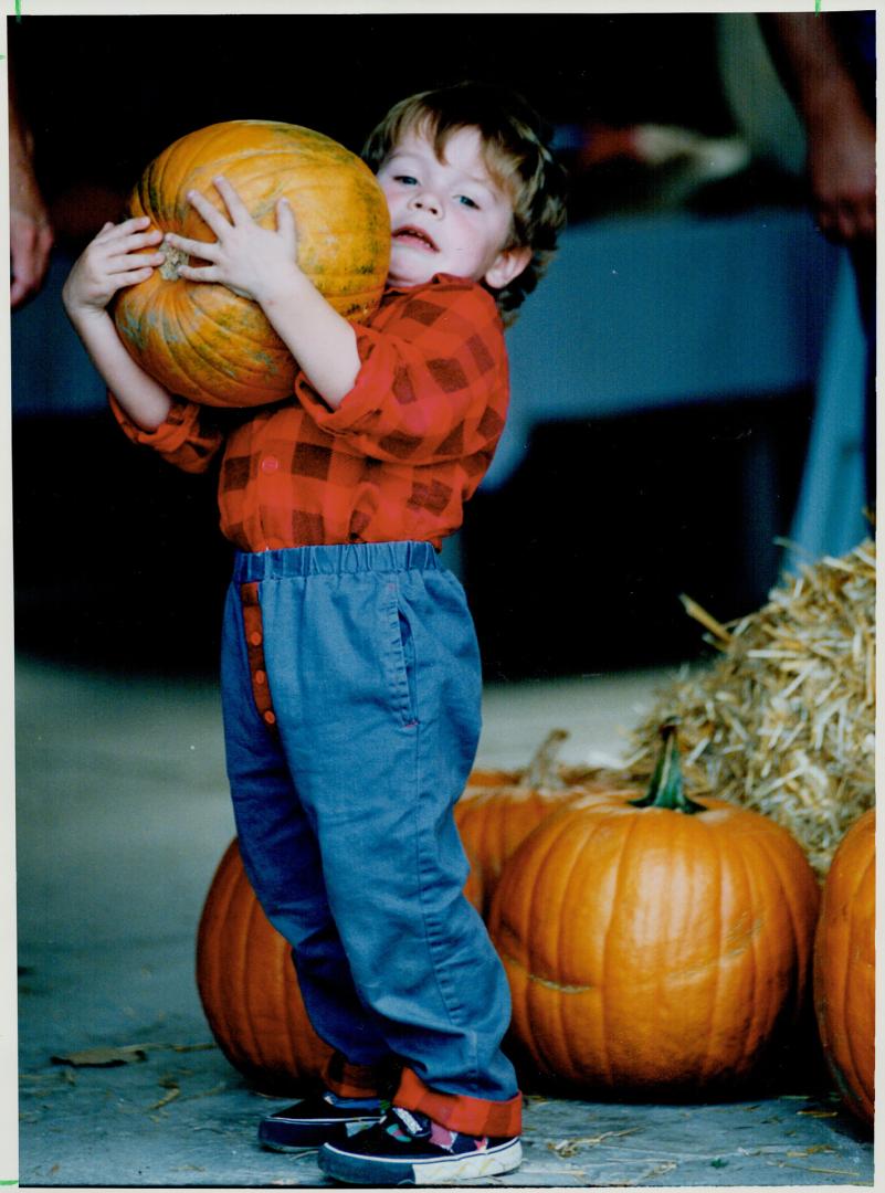 Jeff Egan hoists a big one - for a 2 1/2-year-old - while at the Woodbridge Fall Fair with his parents