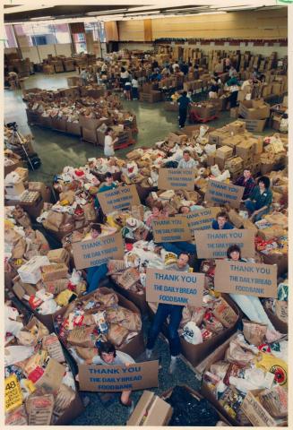 Well done! Volunteers helping to sort and box food at a Pacific Ave