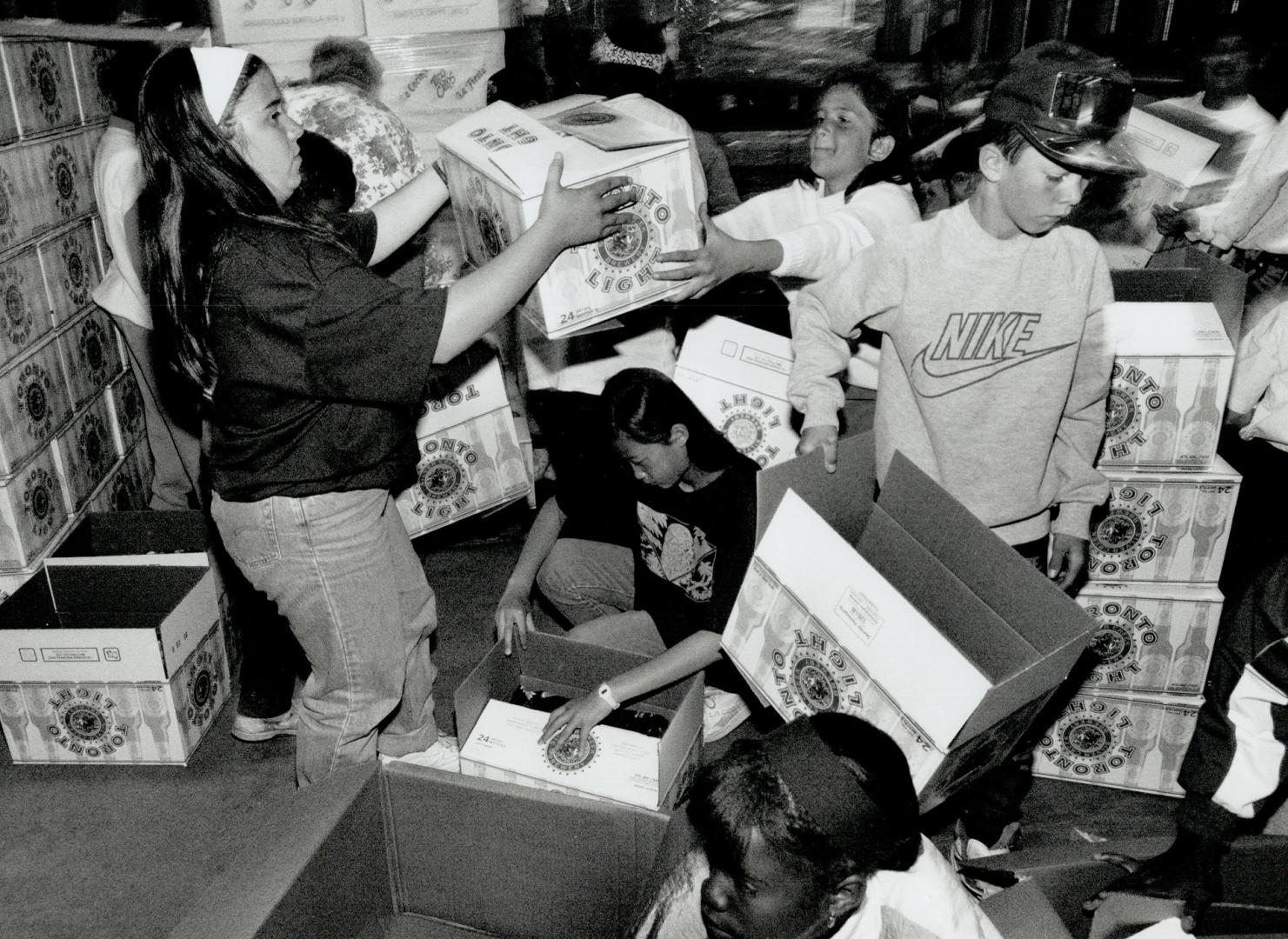 Lesson in life: Students in a Grade 6 class at Scarborough's Macklin Public School help sort food for Metro's 200 food bank programs