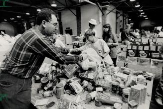 Helping out: Nick Renda of Scarborough spends part of his Thanksgiving breaks yesterday sorting Daily Bread Food Bank donations at the CNE Horticulture Building