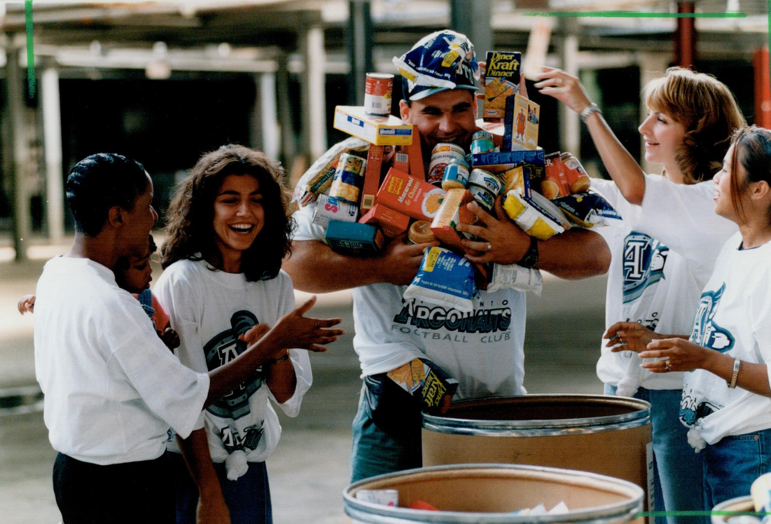 Argo player's wives with donations for Daily Food Bank