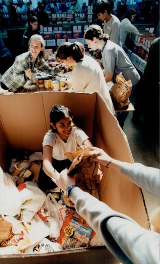 Toronto's Daily Bread Food Bank Lisa Kayaniyil, 14, helps out