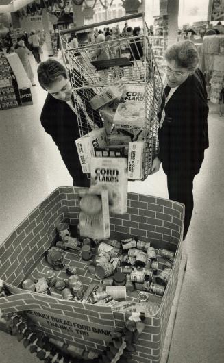 Helping Hand: Miracle Food Mart Managers Peter Sgarbossa, left, and Aggie Fedrigo lend support to the Daily Bread Food Bank at Thorncliffe Market Place