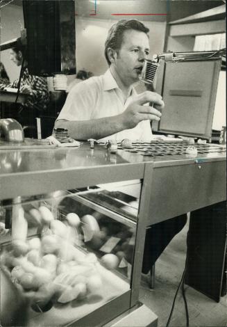 Reg Hotham calls a number at a bingo night at Club Kingsway while hundreds of players listen breathlessly, and mark their cards accordingly