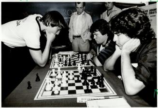 Making his move, Alex Kuznecov, 16, left, ponders a move against one of 23 opponents in a chess demonstration last night at the Scarborough Town Centr(...)