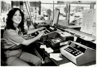 Her 9 by 5 ft. cage doesn't bother Laurie Jill Wood, cashier at Esso Self Serve Gas Kiosk, Yonge and Steeles. 'You have less room to litter up,' she says