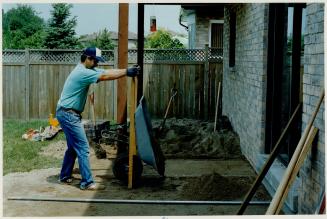 Sand is dumped on to the copacted base that will hold the paving stones