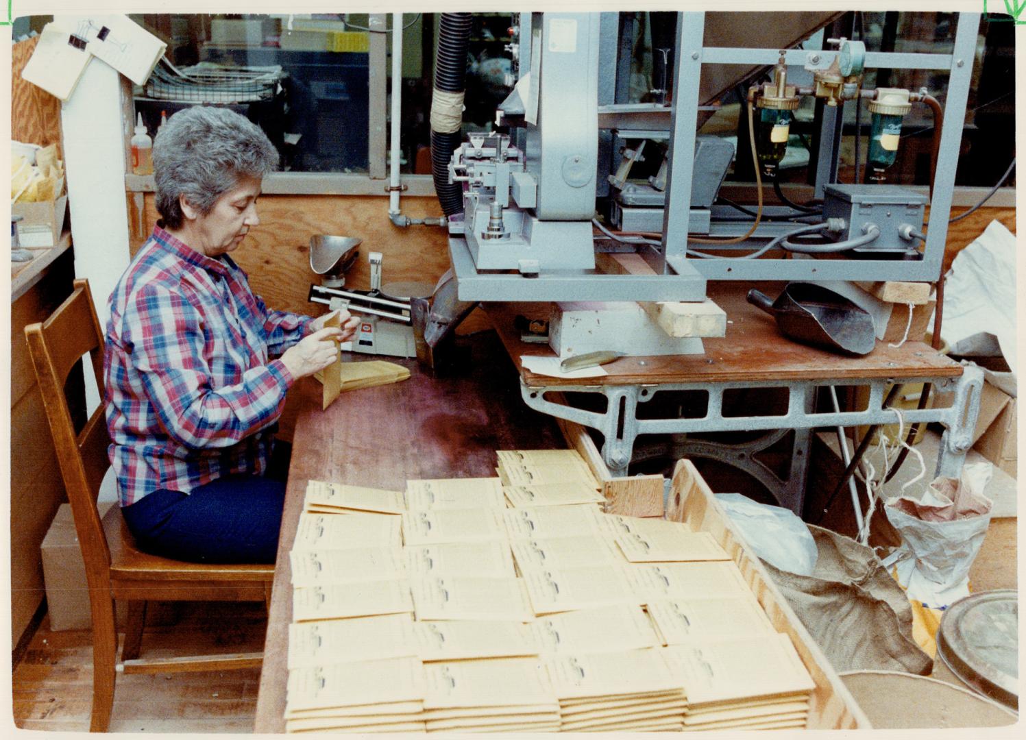 Packing seeds: Renee Baker packages seeds at the Dominion Seed House in Georgetown