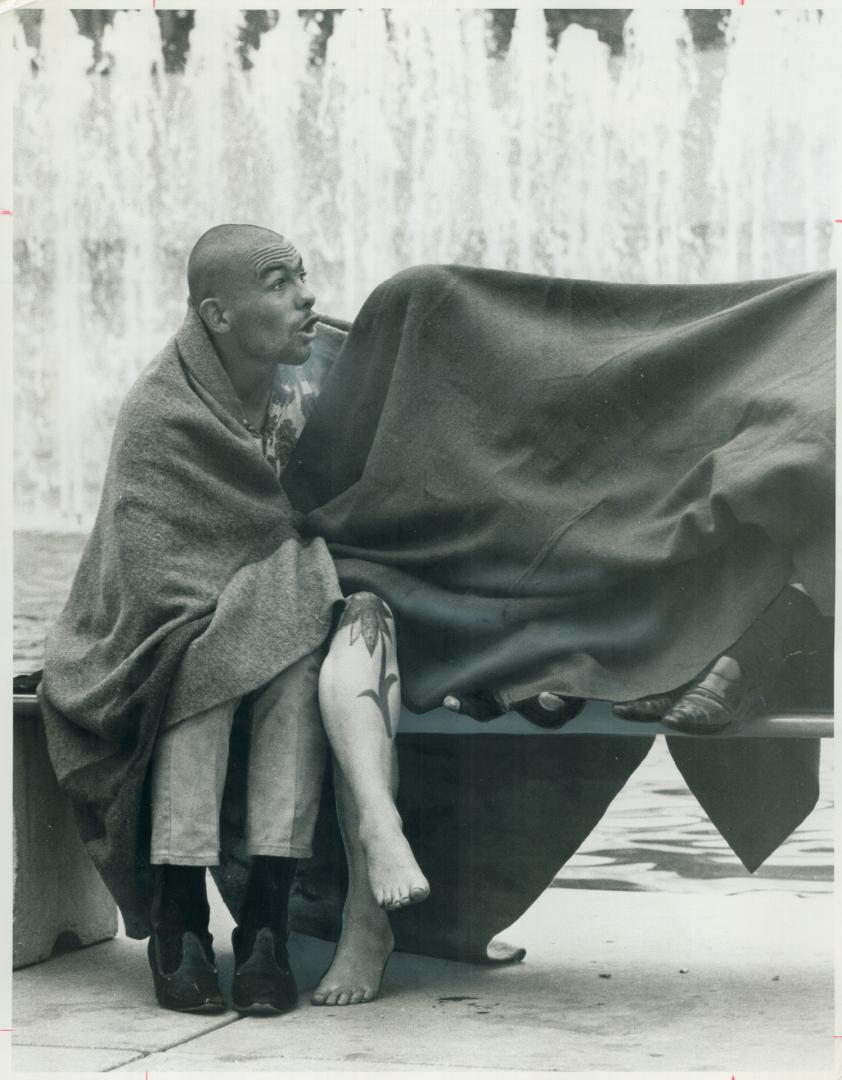 Cool Hippies huddle under blanket, with only their toes protruding, beside their more stalwart comrade at City Hall today waiting for Board of Control meeting