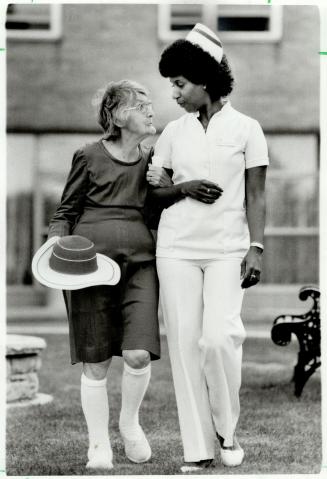 New hope: Nurse Venita Lovelace and Irene Hill, a resident of Greenacres, stroll on the lawn of the home for the aged that was deemed the worst in Metro three years ago