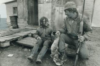 Cree Trapper Philip Cox, shown at home with daughter, Evelyn, 8, is one of the few Indians who still rely on trap lines for most of their income. Cox'(...)