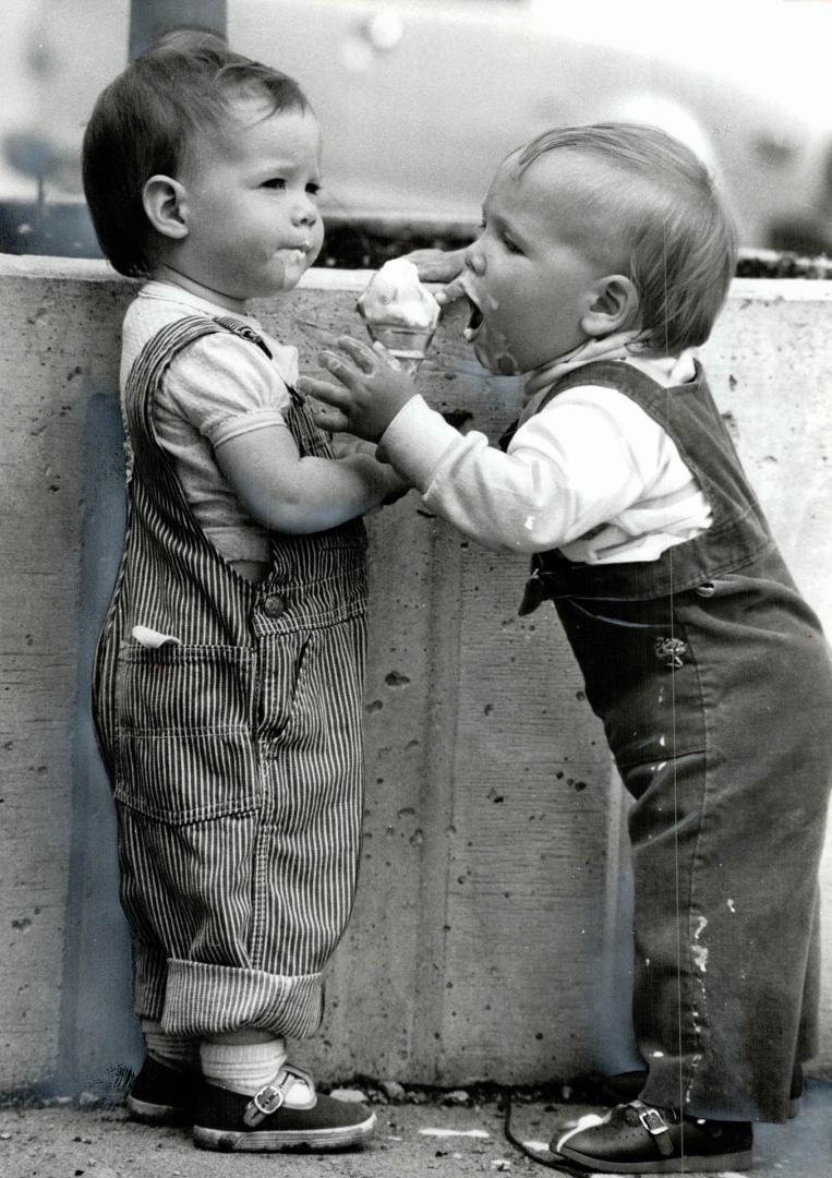 Sweet two, When it's hot, there's nothing like an ice cream cone to make things sticky, Ashley McDonald, 2, doesn't mind sharing her cone with 1-year-(...)