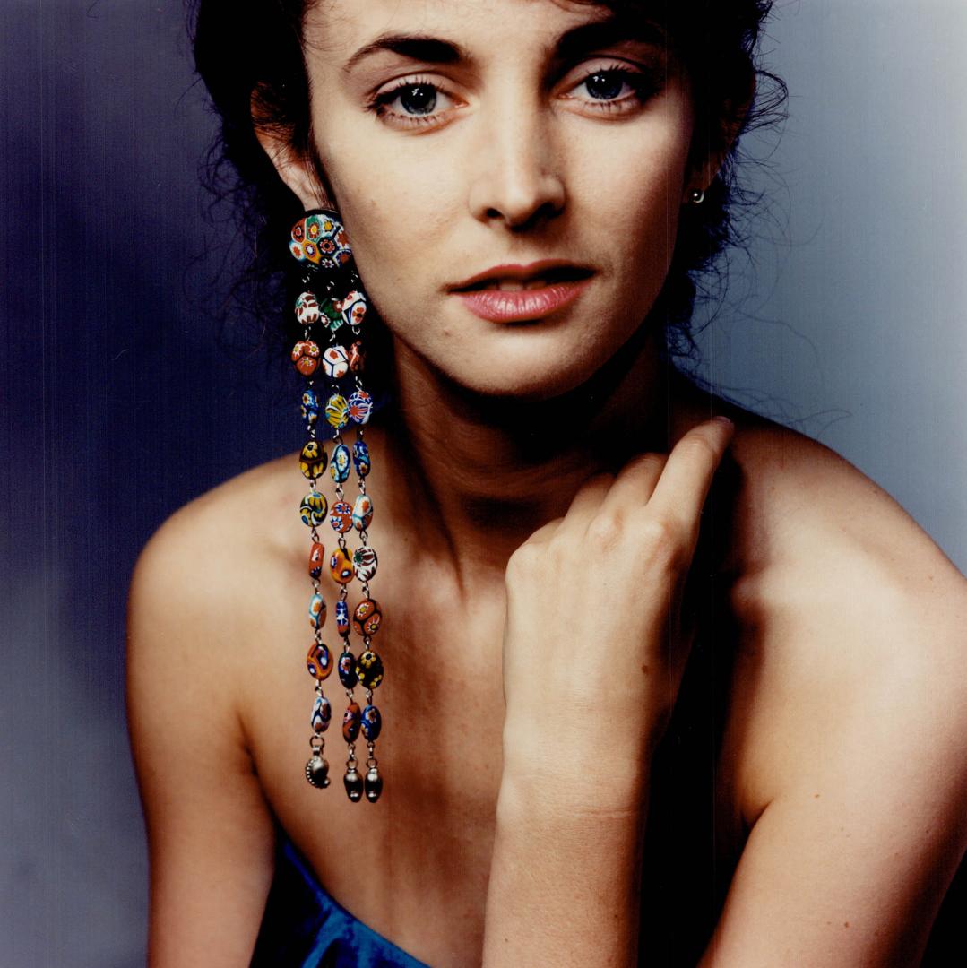 Long and Short: A cascade of painted ceramic beads from Fabrice in Toronto, $295, is paired with a tiny silver stud, $25