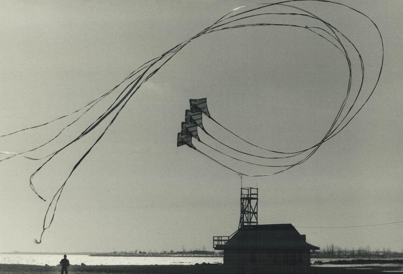 Perfect weather to go fly a kite, Bernard Woo takes advantage of a brisk wind coming off the lake to put his stunt kite, with its long tails flutterin(...)