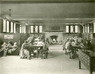 Image shows an interior of the branch. There are a lot of children sitting at the desks.