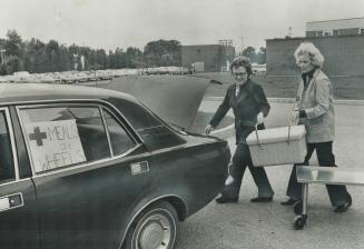 Services like meals on wheels depend on their volunteer workers, They put hot meals in trunk of car for delivery to elderly and handicapped