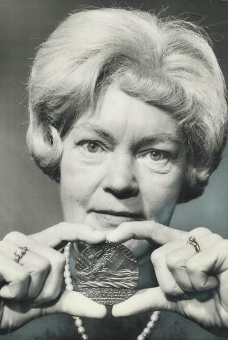 Norah Irwin holds a coin struck to mark the sinking of the Lusitania in 1915