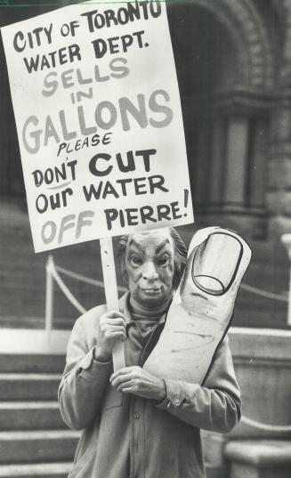 Metric protests: An anti-metric protester's sign puts a finger on the problem at old city hall yesterday when two gas station owners appeared charged with selling gasoline in gallons