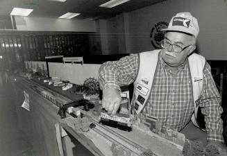 Big kids stuff: Bill Clark of Oakville tinkers away at the Erin Mills Model Railroad Association's display, on until Christmas at Sheridan Place Mall