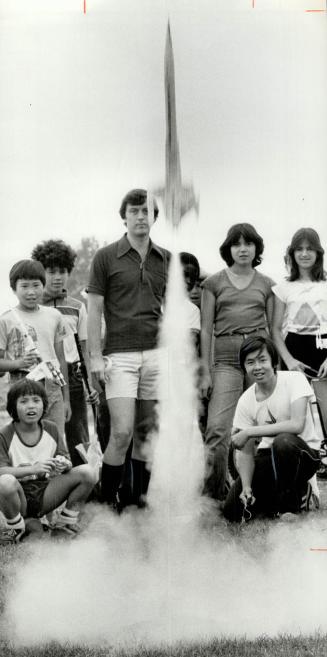 Blast off a success: Rocketry teacher Paul Stevens and his students stand back as the Yeung brothers' rocket takes off