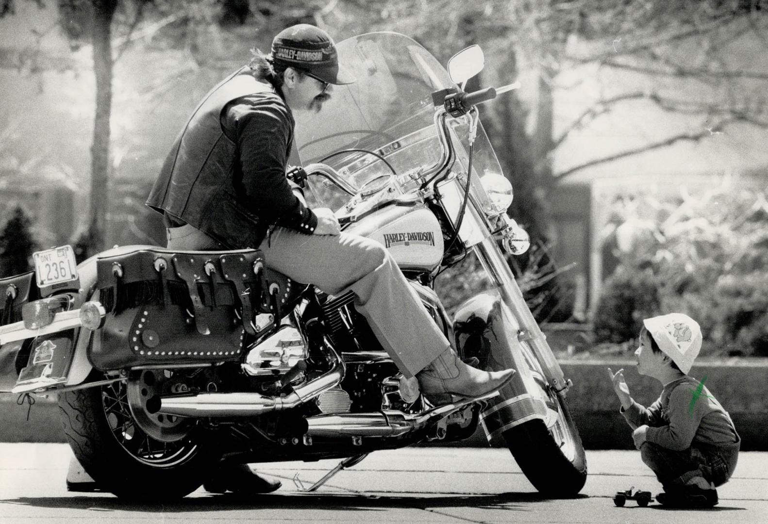 Riding high: A Harley-Davidson fan shows his two-wheeler at a Toronto motorcyle safety observance