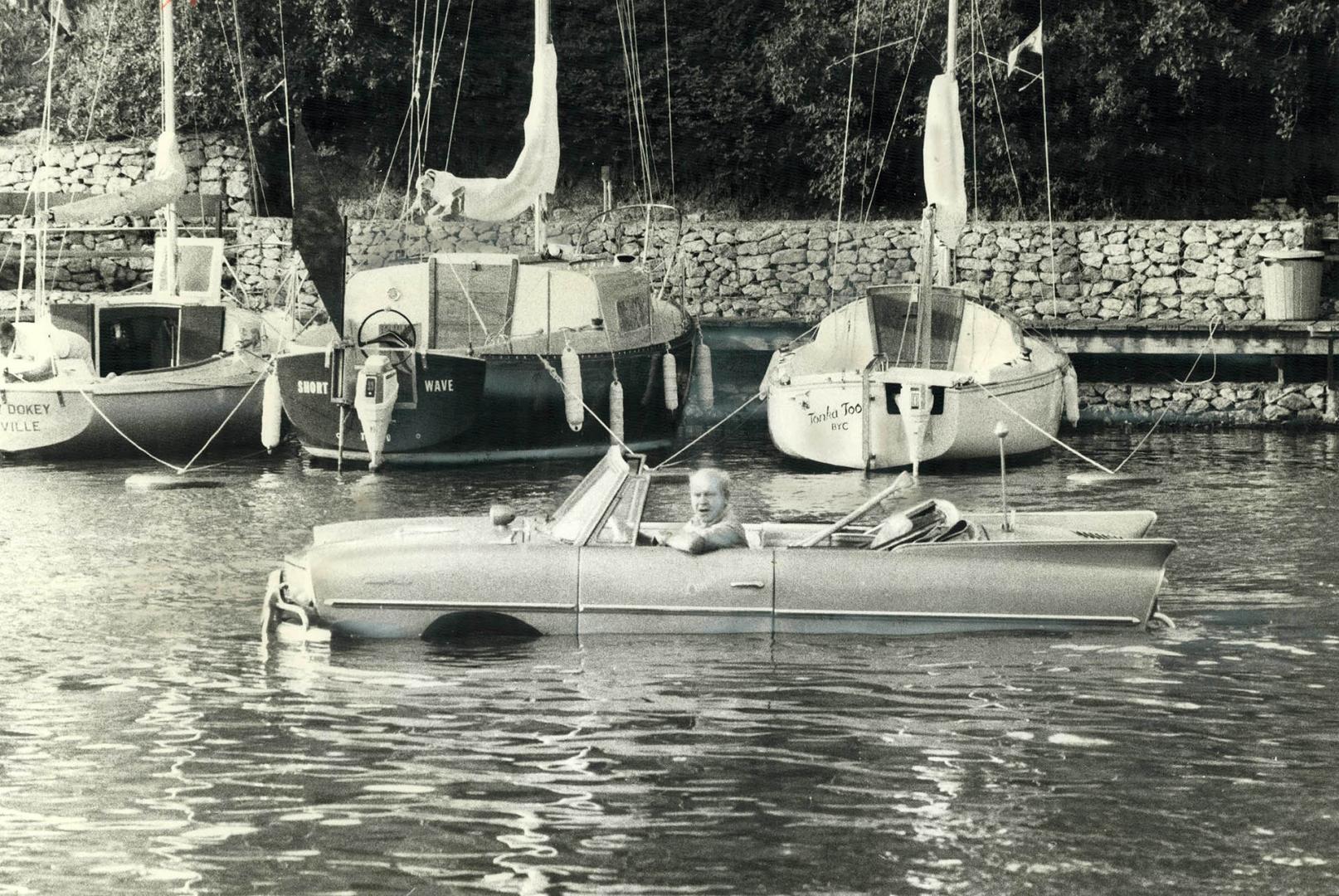 Down to the sea on wheels, The sight of Amos Beaudet of Milton driving his 1965 Amphicar down Oakville Harbor last night past moored yachts - and then(...)