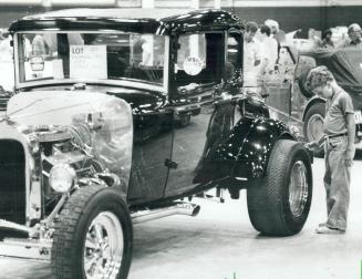 Fascination: The oversized tire on a 1930 Ford Street Rod totally captivated this young lad, who probably thought it was just the thing for cruising up Yonge St