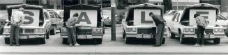 Could I Interest You ....., Sidewalk shoppers peer at the innards of used Cadillacs at Addison Cadillac on Bay St