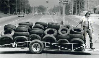 Tired of Illegal Dumping, Morgan smith steadles a trailer load of tires collected by about eight neighbors yesterday on Galloway Rd. near Kingston Rd. in Scarborough