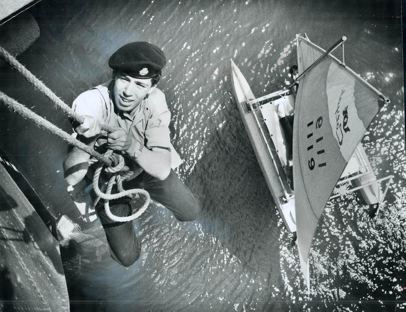 Using a bosun's chair, Sea Cadet David Eadie goes over the side of the destroyer HMCS Haida, moored at Ontario Place, to check the bow for rust spots.(...)