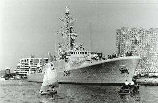 Small boats flank the HMCS Terra Nova as it arrives in Toronto harbor today