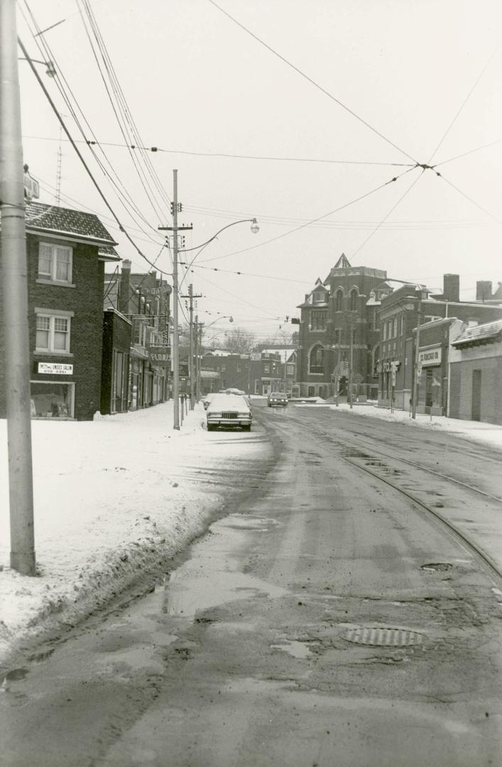 Image shows a street view with some house on both sides.