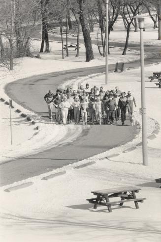 Image shows a group of people running along the street.