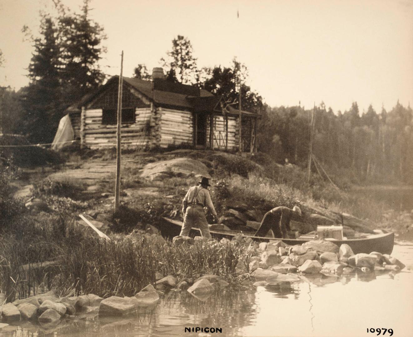 Nipigon 10979 [cabin, men unloading canoe]