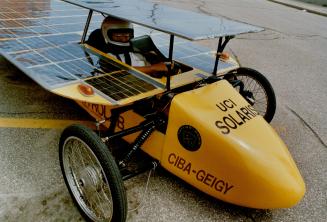 Under Cover: Mechanical engineering student student Paul Yeh, 24, is almost hidden by the solar panels of his 380-watt fibreglass car, which took a year to build