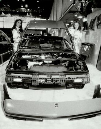 That's some bodywork. Two models bolted the plastic base body of this Pontiac Fiero together in 2 minutes yesterday at the International Centre (home (...)