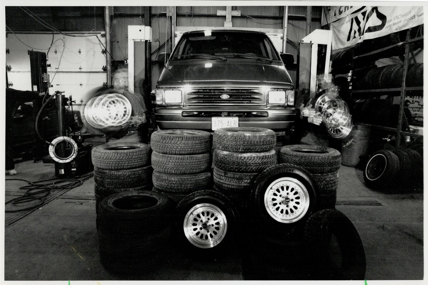 On a Roll: Tom Pilisch and Andy Kantor of Tiremag in Concord hustle wheels off our test minivan for John Mahler, who tried out eight 70-series tires