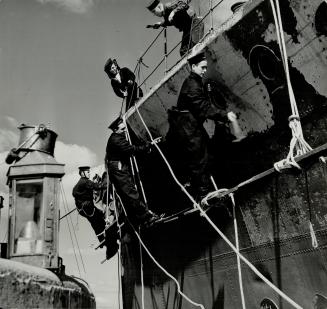 Canadian Naval Men are kept as busy on shore as at sea