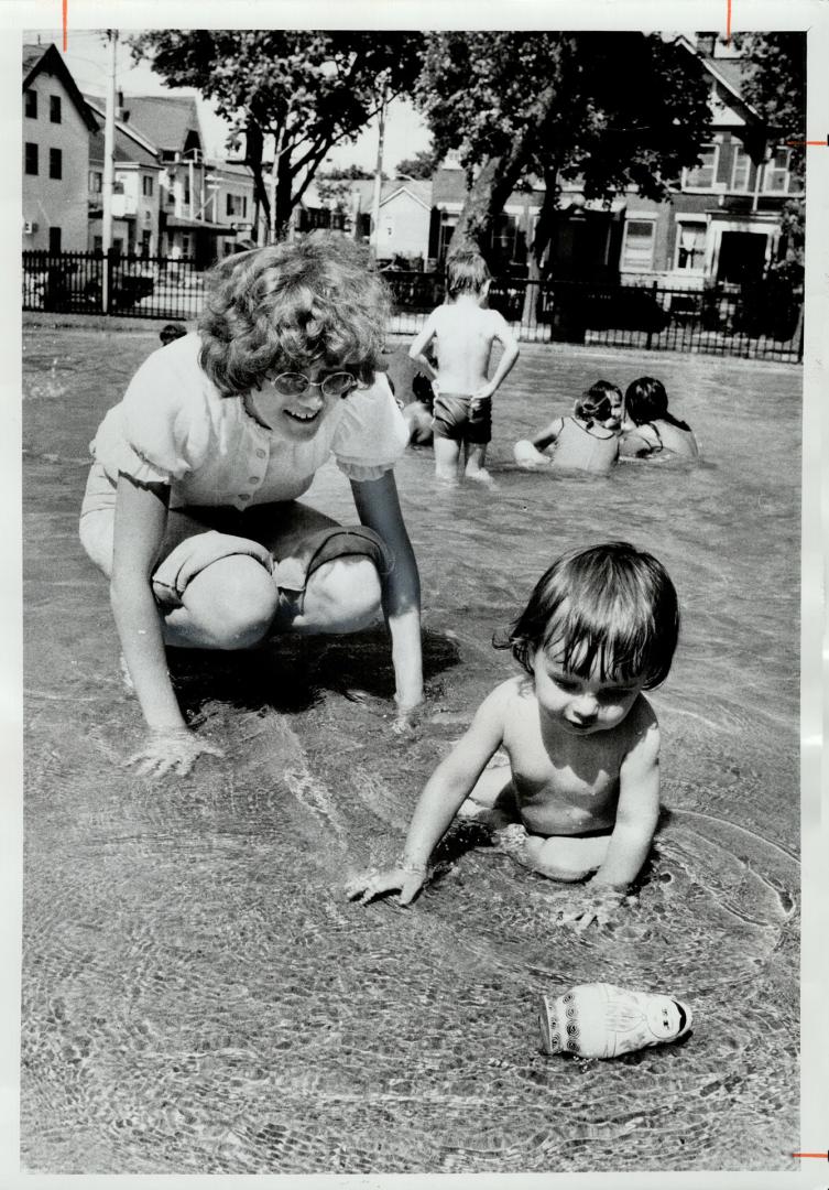 Undressed for occasion, 17-month-old Alexander Tymchyshyn played in wading pool near Brunswick Ave