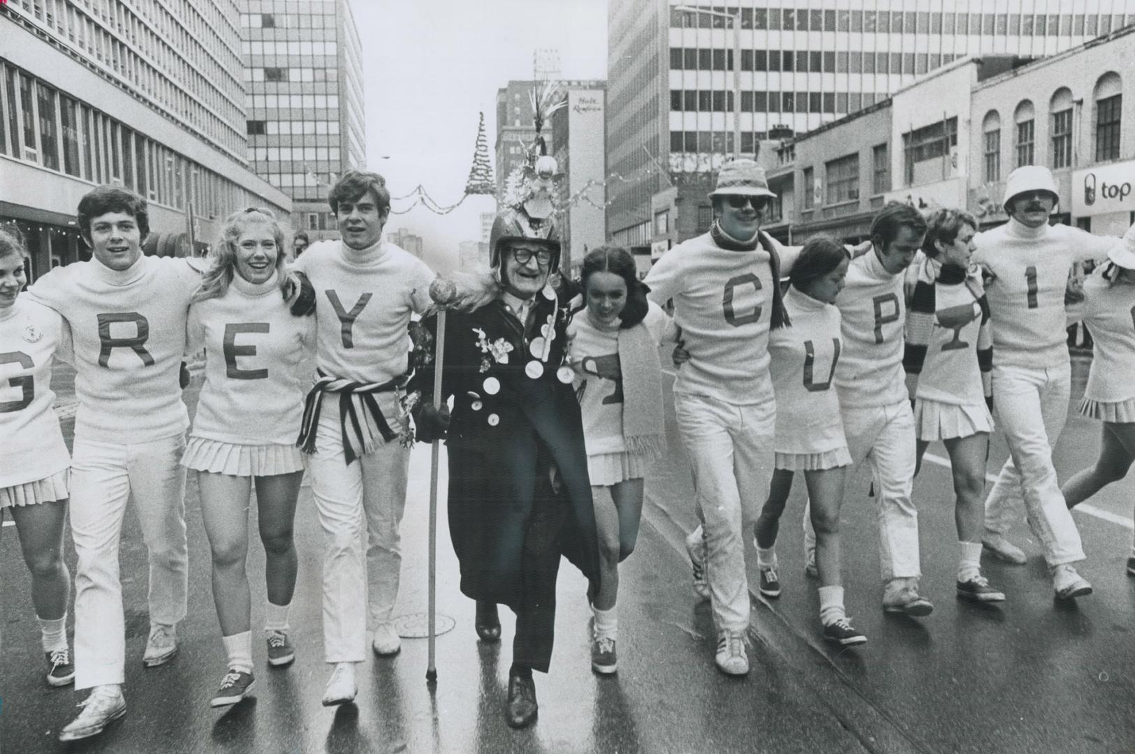 For the young, or for veterans like the oldster at centre, today was a day spelled 'grey cup' day as parade moves through Tor[Incomplete]