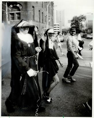 Gay apparel: Among the 1,000 homosexual rights supporters who marched through downtown Toronto yesterday were these members of the Sisters of Perpetual Indulgence