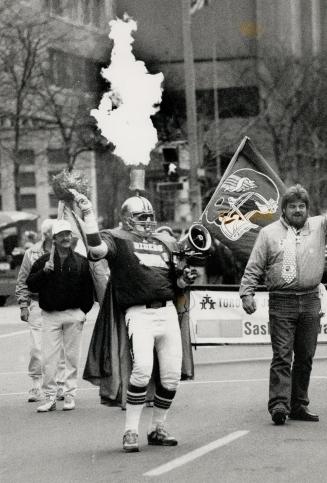 He's The Flame - Sandy Monteith, a Roughrider fan, creates a startling effect with a blowtorch on his head