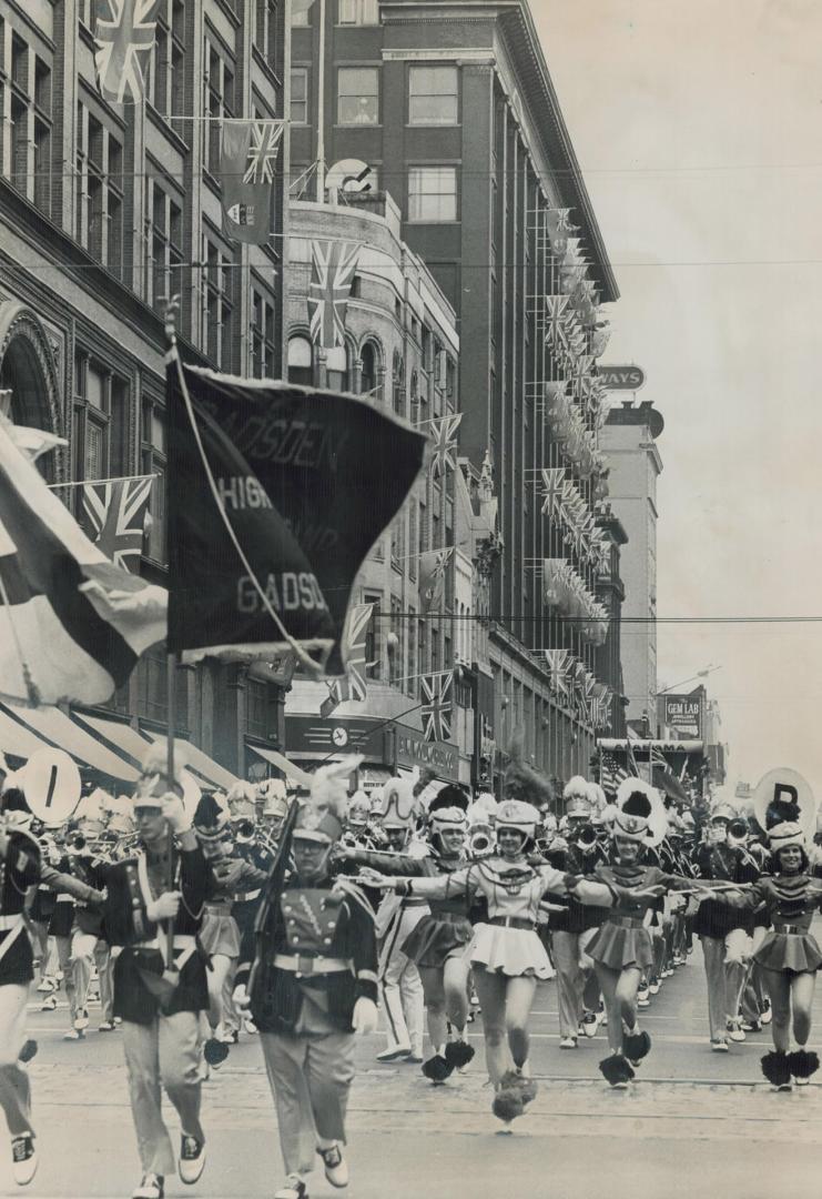 High stepping majorettes give a dash and verve to the gigantic Lions parade which moved through downtown Toronto today to the music of nearly 70 bands(...)