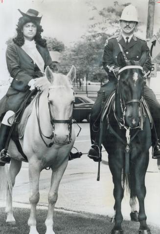 King Billy is escorted by Constable Michael Best in this year's Orange parade