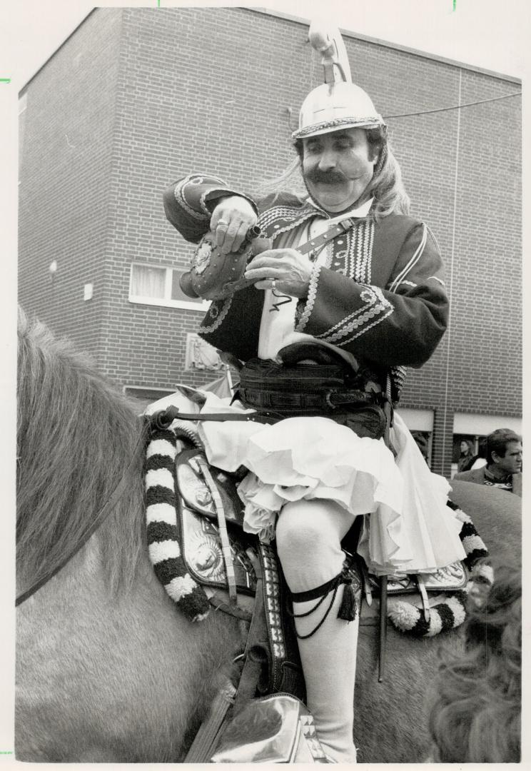 Independence day, Kostas Pavlou, 7, left, carries Canadian flag in parade marking Greek independence, while Peter Galanis, above, pours himself a drink to ward off the chill