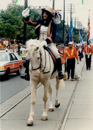 'Glorious 12th': King Billy (Don Vincent) leads loyal Orange-men - and sweepers - yesterday as the Toronto lodge marks the Protestant victory in 1690 at the Battle of the Boyne