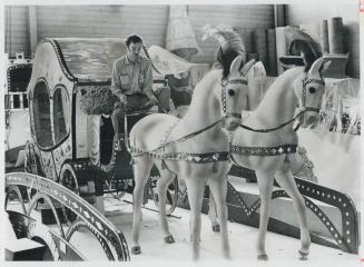 A Brand new carriage made this year for Puss 'n Boots is tested by Bob Wormald, one of the workers at the jolly fat man's Metro headquarters in Etobic(...)