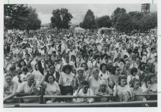 Show of hands: Several hundred people re-affirm their citizenship in a special outdoor ceremony at the CHIN International Picnic yesterday at Exhibition Place