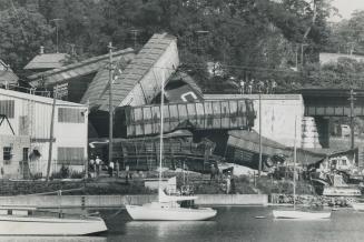 Poisonous weed killer from a 3,600-gallon tank car buried under this spectacular jumble of derailed freight cars, poured into Port Hope's yacht basin (...)